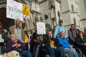 Disabled People Against Cuts (DPAC) and supporters hold a vigil outside the Royal Courts of Justice in the Strand, London. Read more about the campaign here - dpac.uk.net/ Photo: RonF October 22, 2014